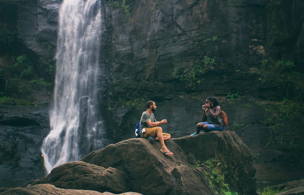 pexels-photo-450441-450441 A serene moment captured by a waterfall in India with a couple enjoying nature's beauty together.