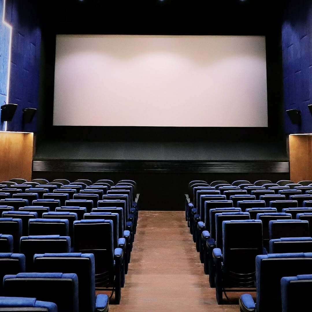 Ega Theatre's modern interior with large screen.